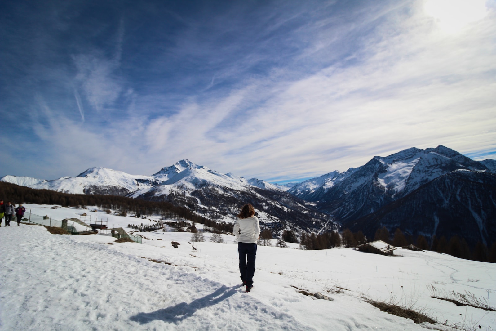 a woman standing on top of a snow covered slope